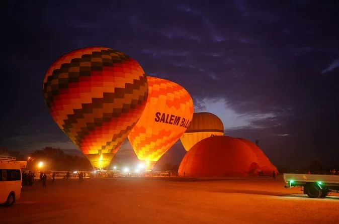 Glowing balloons inflating on a dark launch field